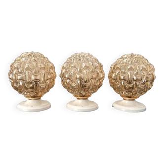 Set of three golden globe wall lights