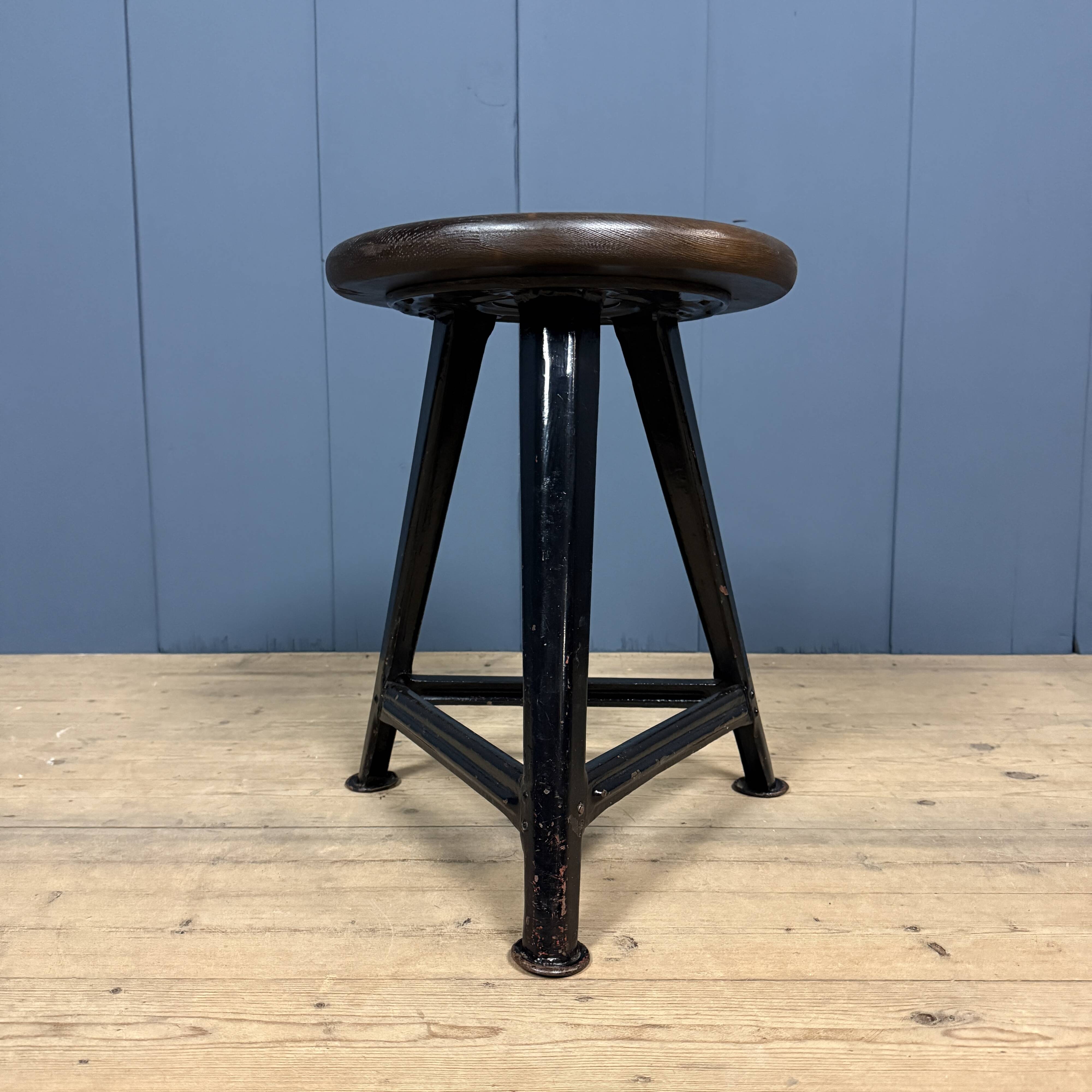 Unmarked black Rowac stool with a dark wood seat.
