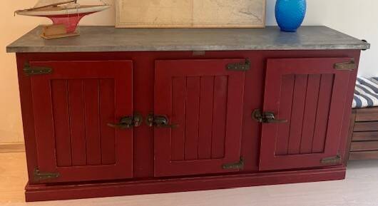 Low red "Guérande" buffet, zinc top, butcher's fridge-style doors