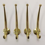 Two curved wall coat racks in brass by Franz Hagenauer, Vienna, mid-20th century, 1950s.