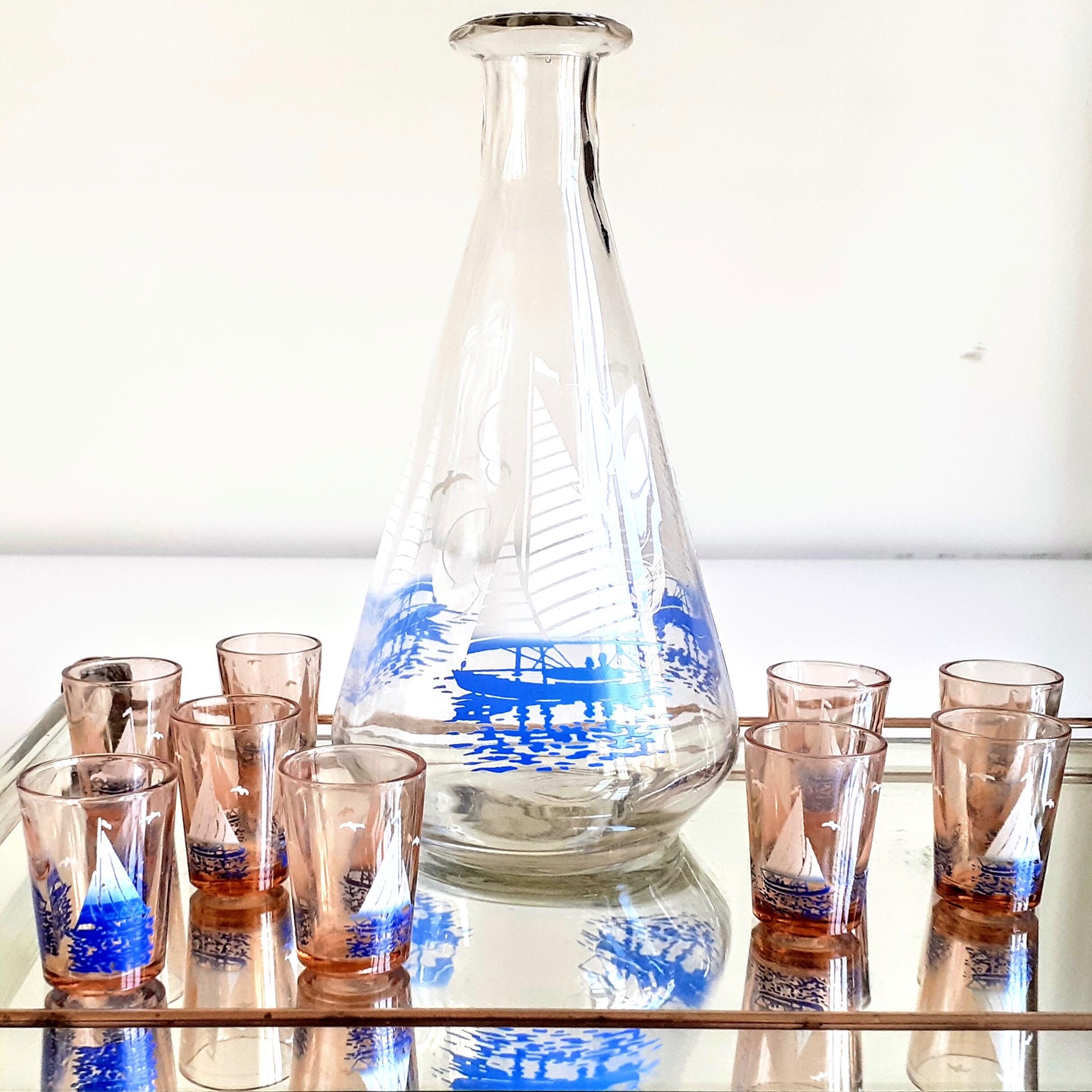 Carafe and 9 liquor glasses decorated with sailboats
