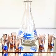 Carafe and 9 liquor glasses decorated with sailboats