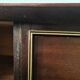 Dark wood sideboard with brass finishes and compass feet