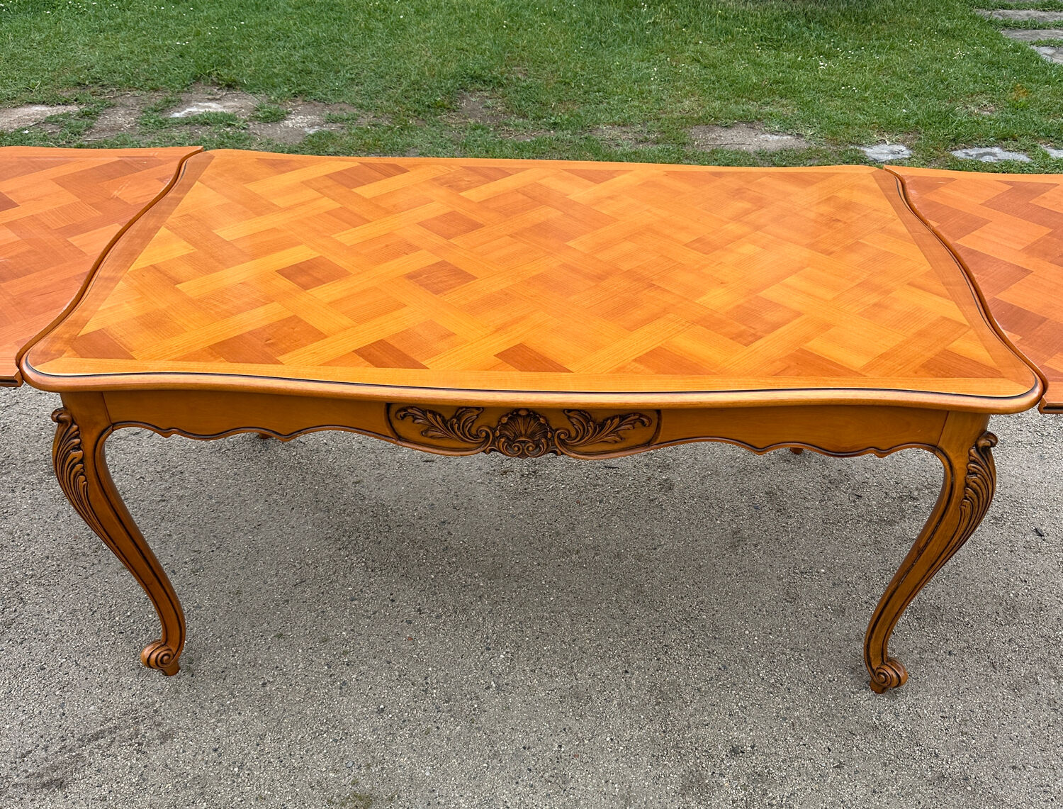 Antique extendable table in cherry wood and marquetry in the Louis XV style.