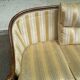 Two-seater Louis XVI canapé in golden beige fabric and curved solid wood.