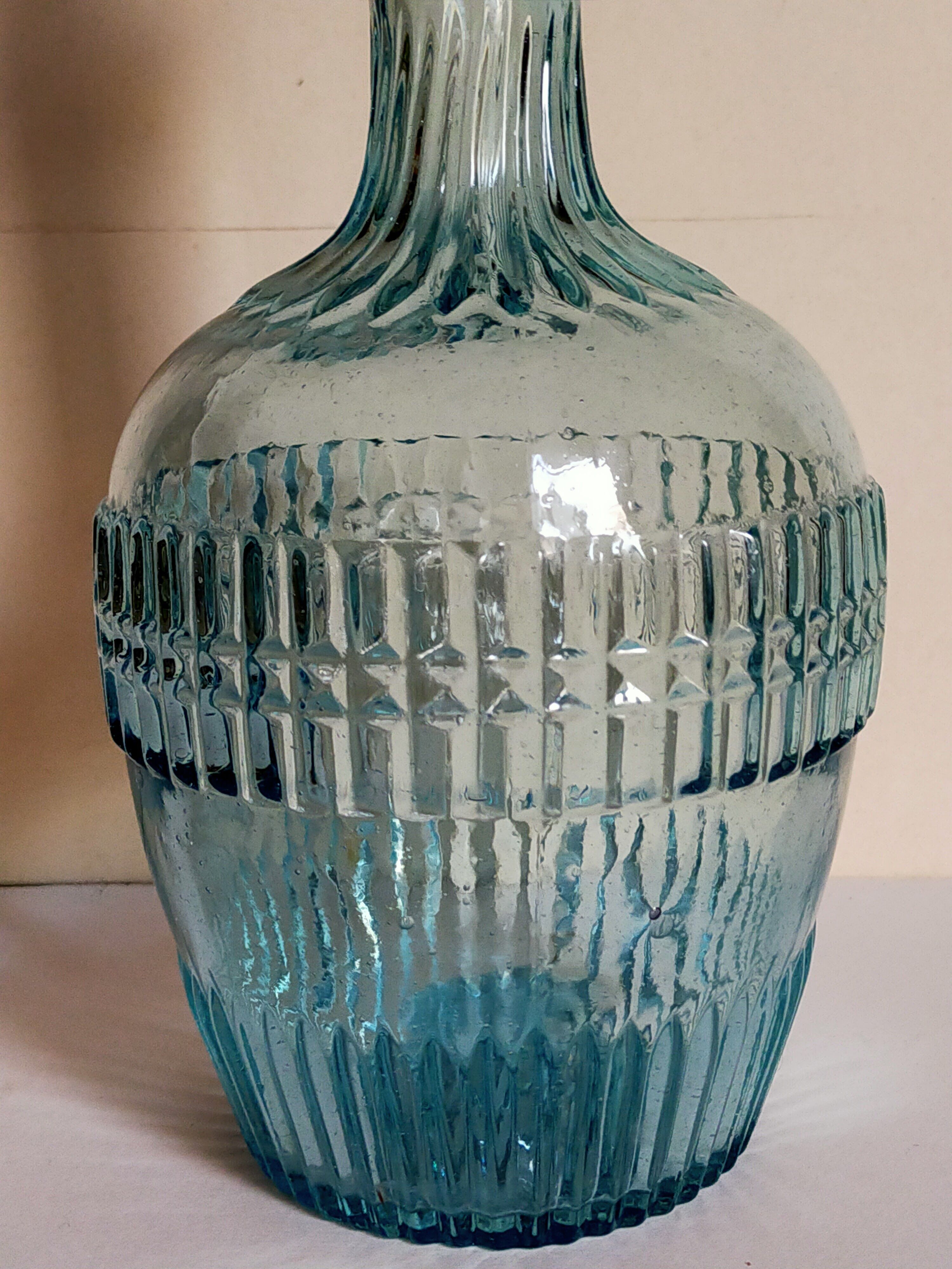 Blue glass carafe with vintage pegs