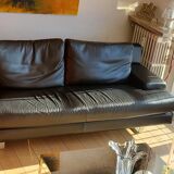 Black leather three-seater sofa