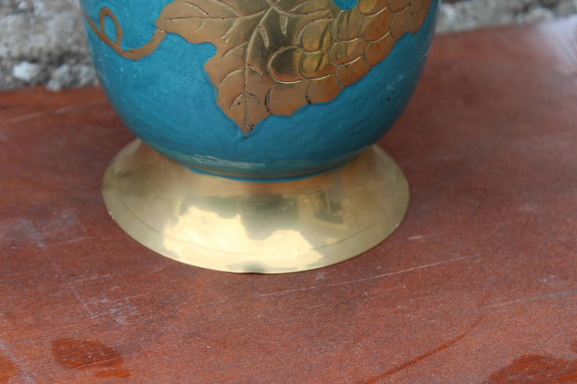 Vintage turquoise brass champagne bucket with grape decoration.