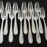12 cake forks and a silver metal server.