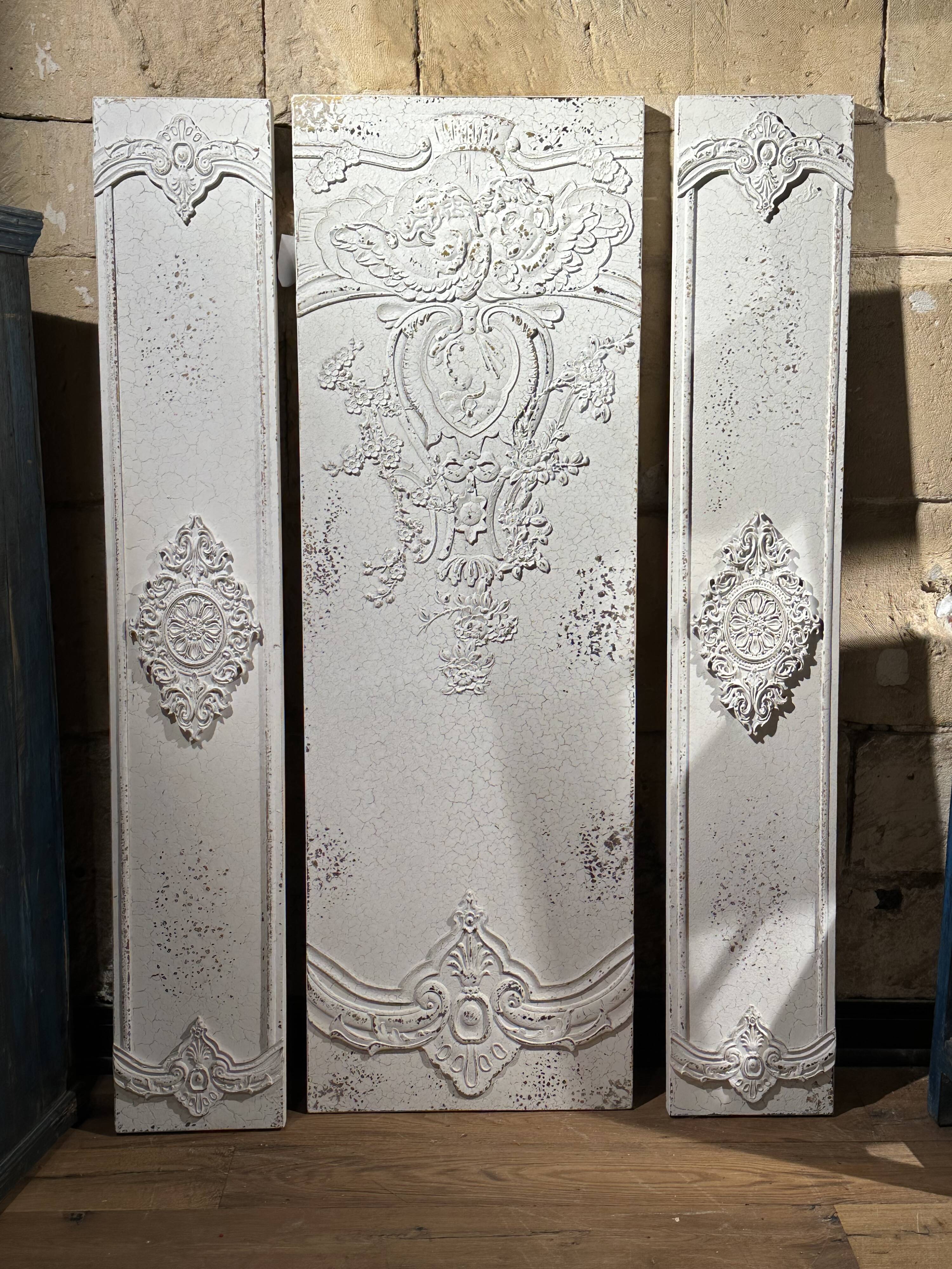 Wall decoration in three pieces, triptych of relief decoration on weathered wood, white and gold,
