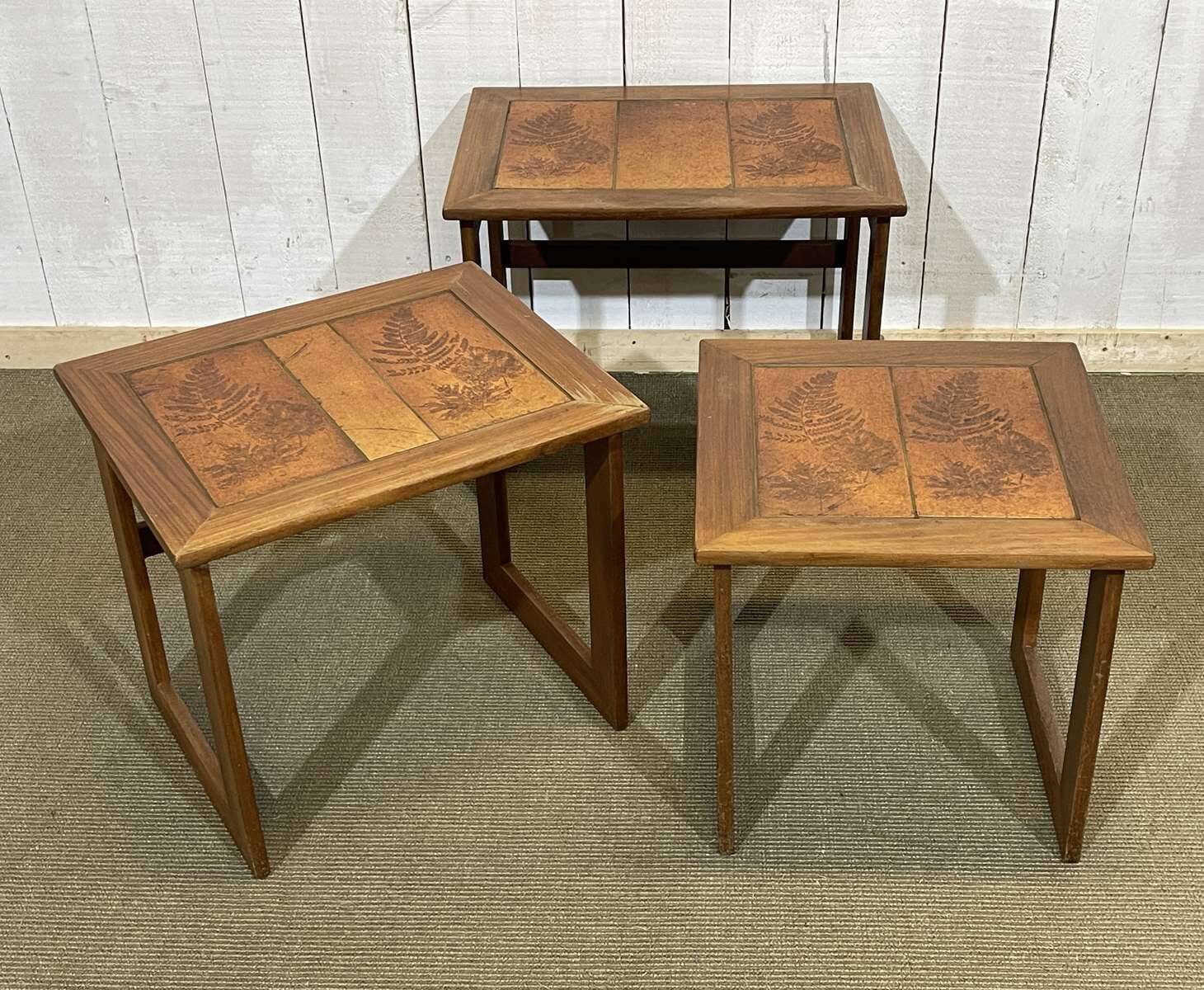 Set of 3 nesting tables in teak with tiled tops.