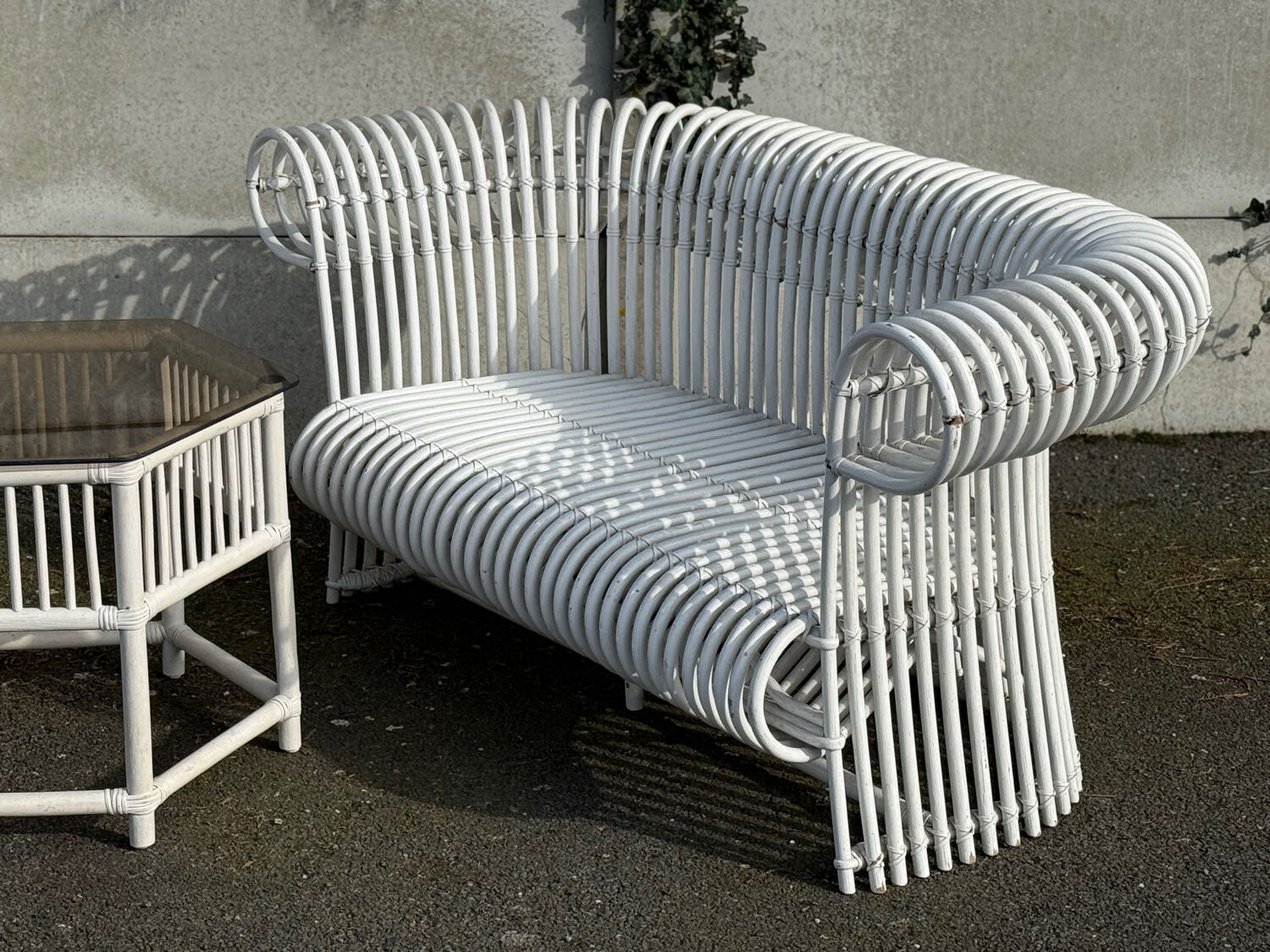 Rattan lounge with two two-seater sofas and a white coffee table.