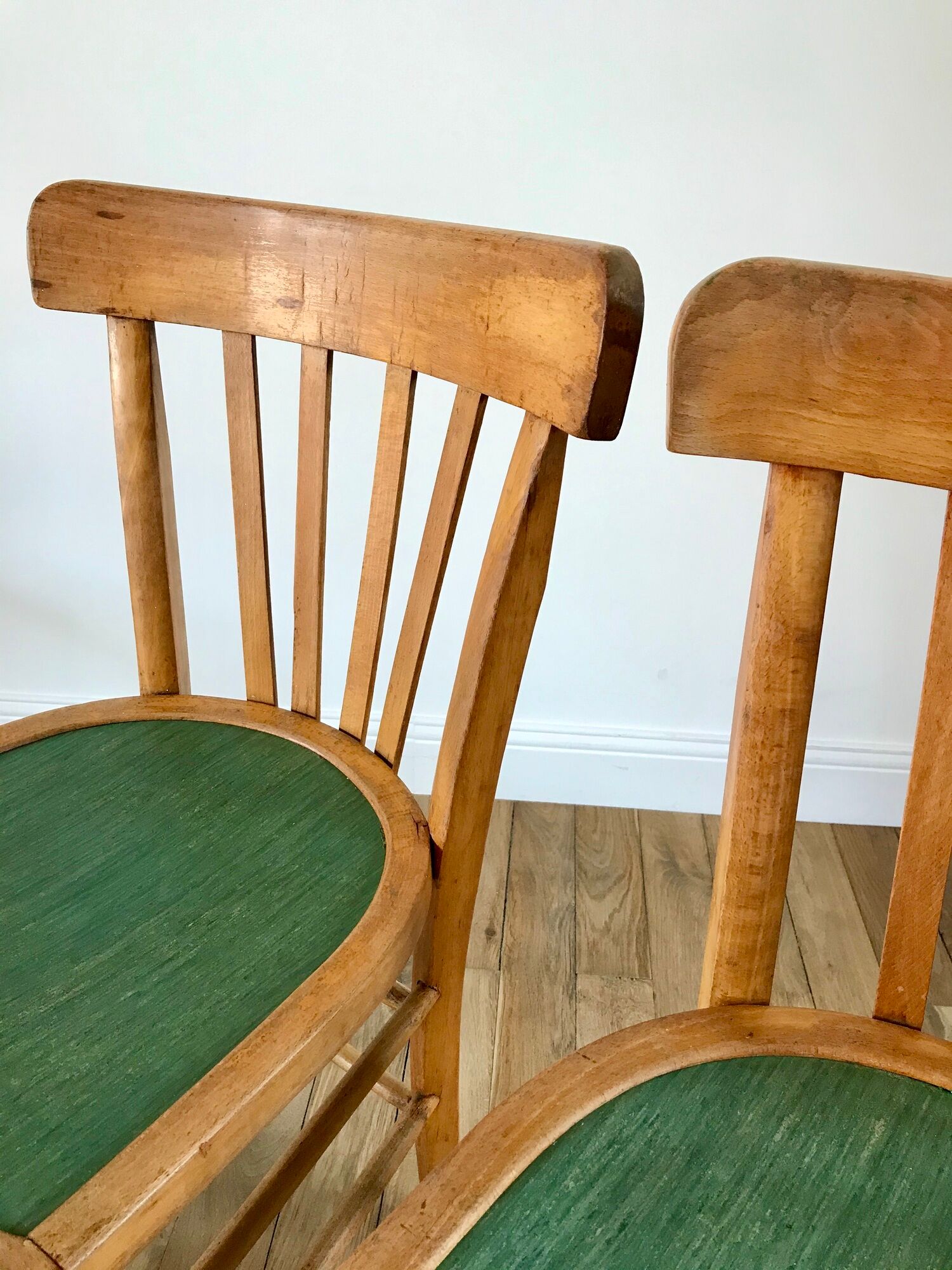 Pair of bistro chairs in light curved wood and green seat 1950s
