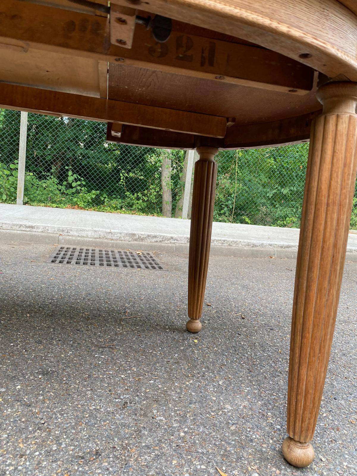 Large stripped solid oak dining table in Louis XVI style with 3 extensions.