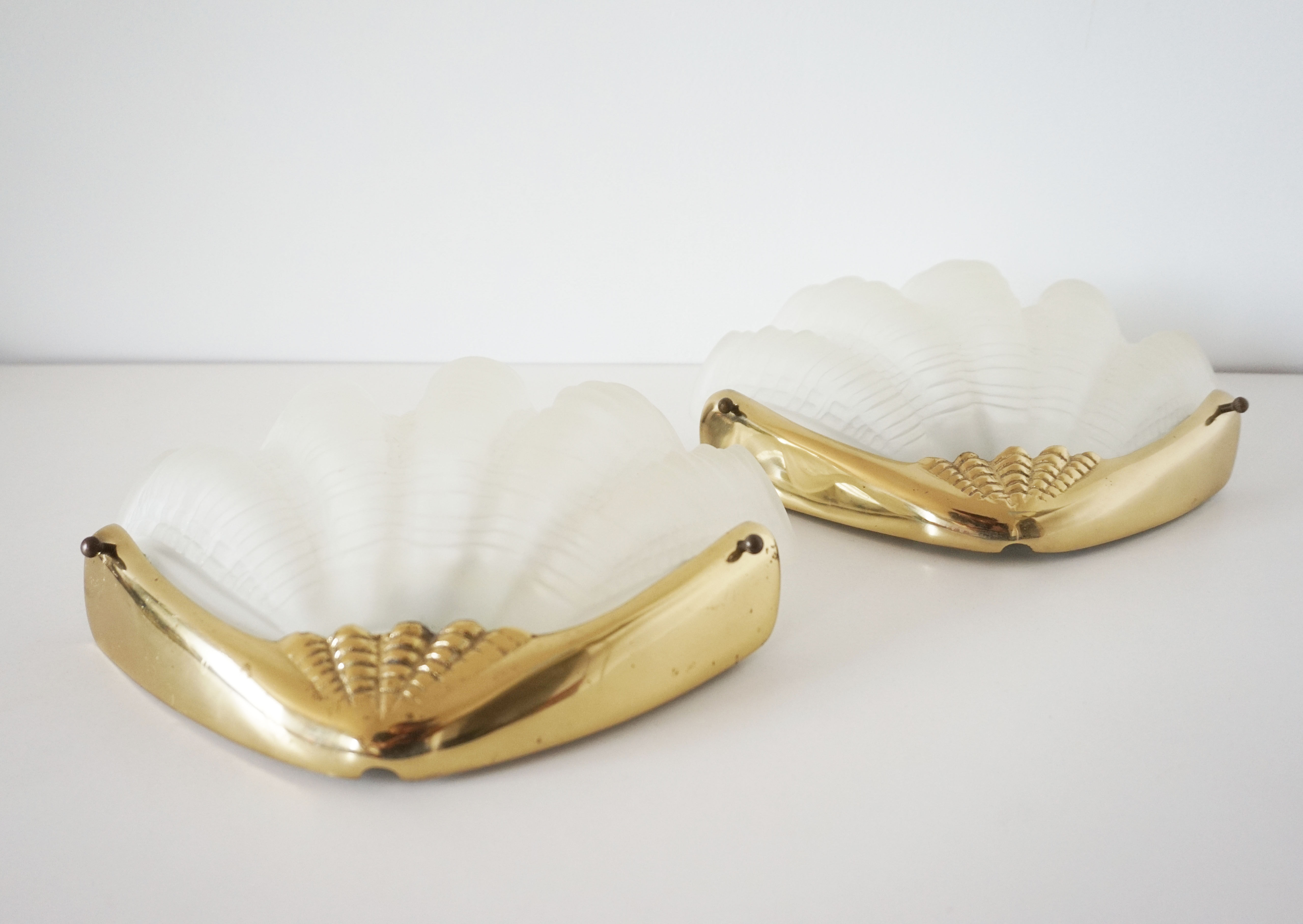 Pair of glass and gold metal shell sconces