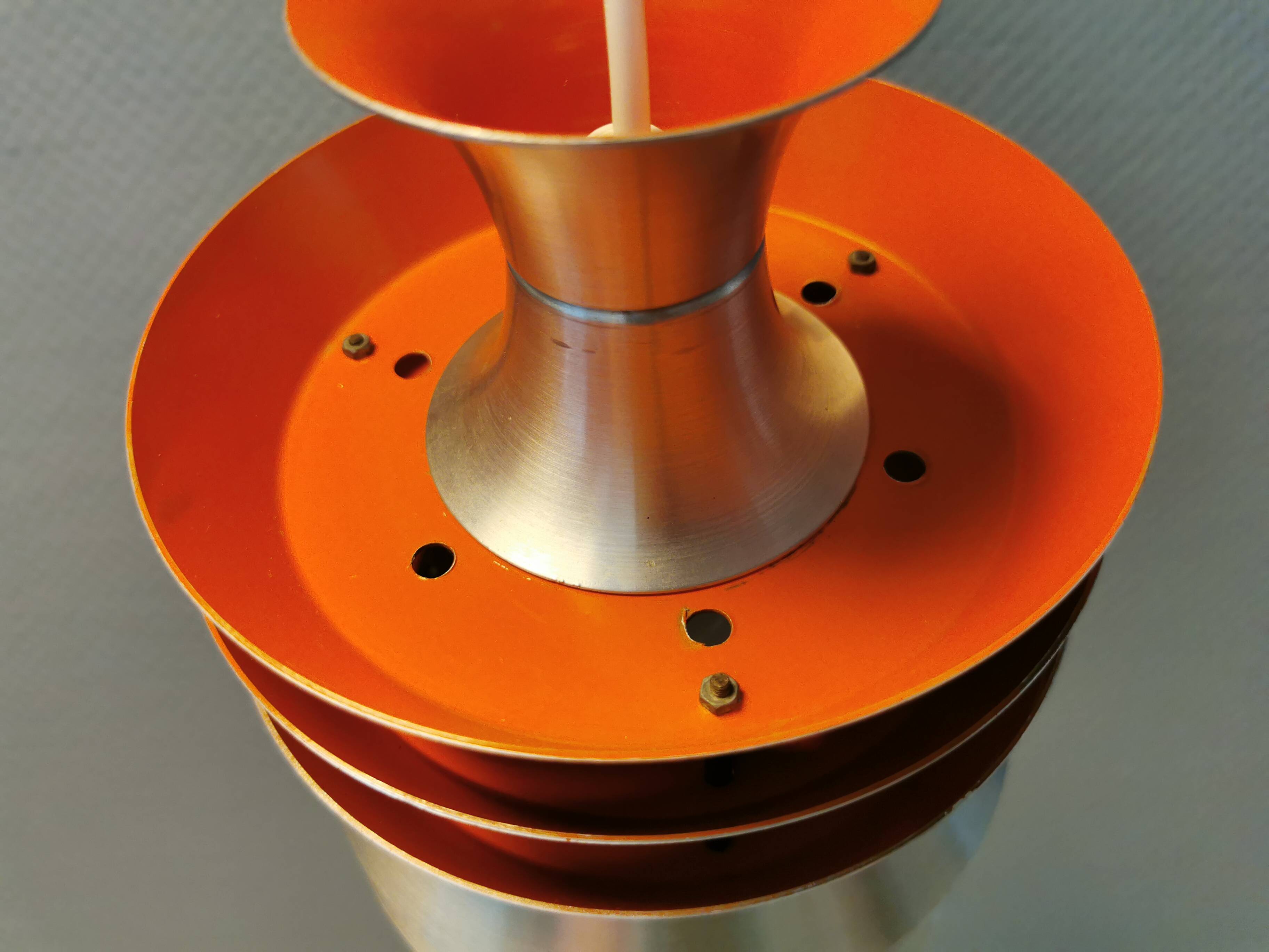Danish/Swedish hanging lamp, in silver-coloured aluminium with orange interior paint.