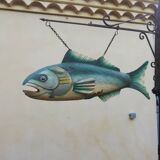Panel depicting a fish in sheet metal
