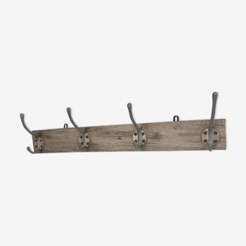 Old patères on aged wooden coat rack