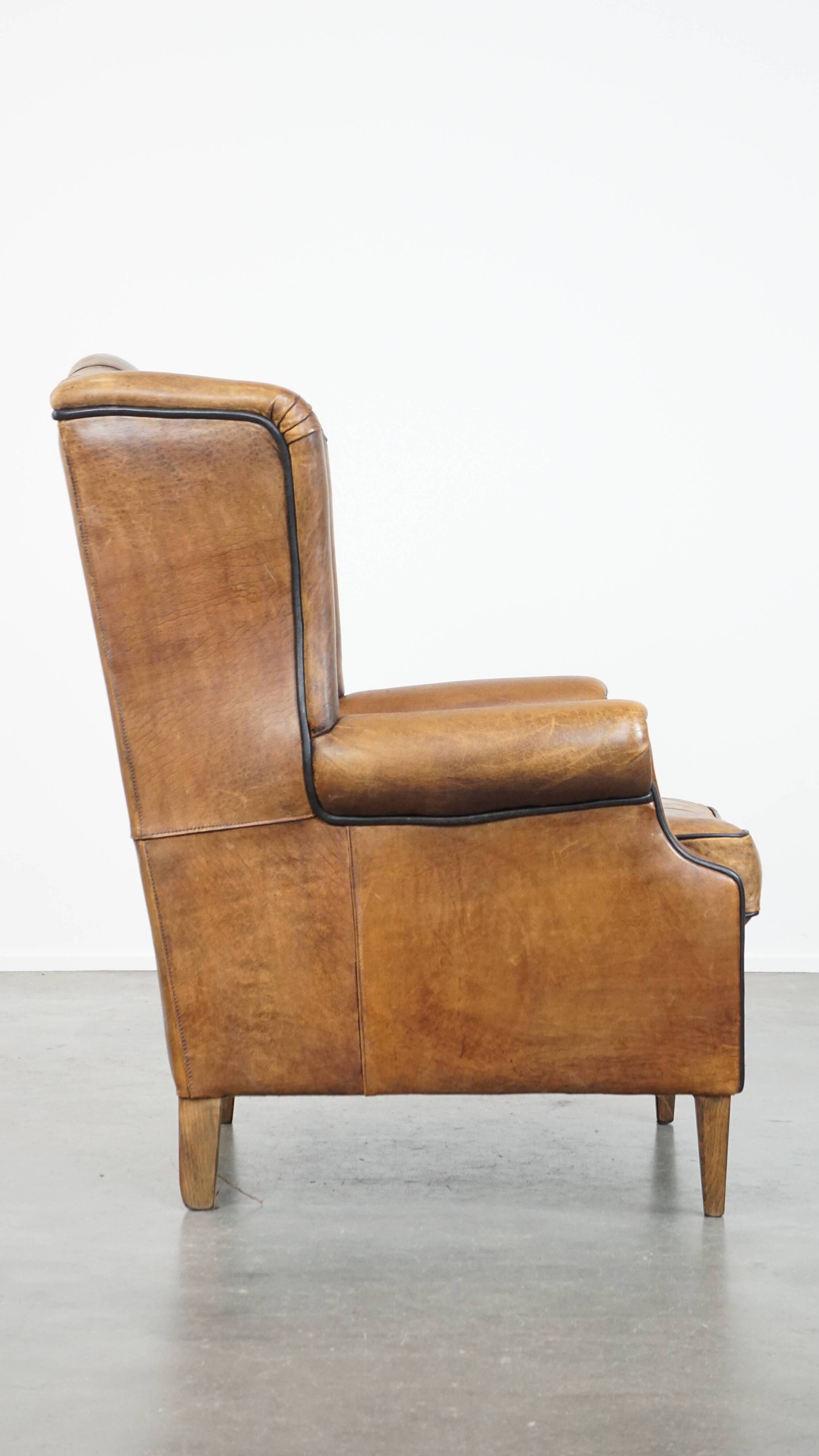 Sheep leather wingback chair finished with black piping