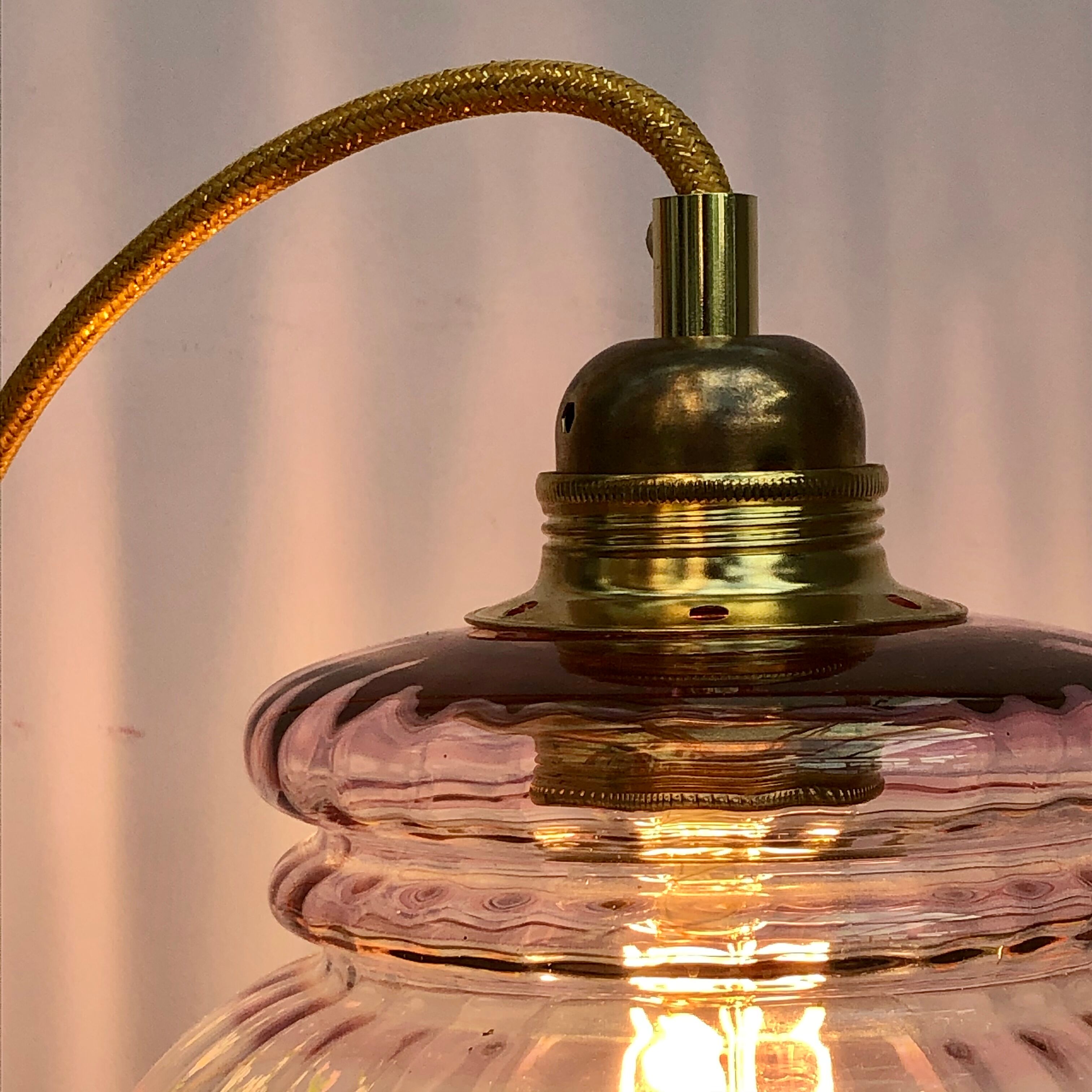Vintage pink glass hand lamp with flower motifs