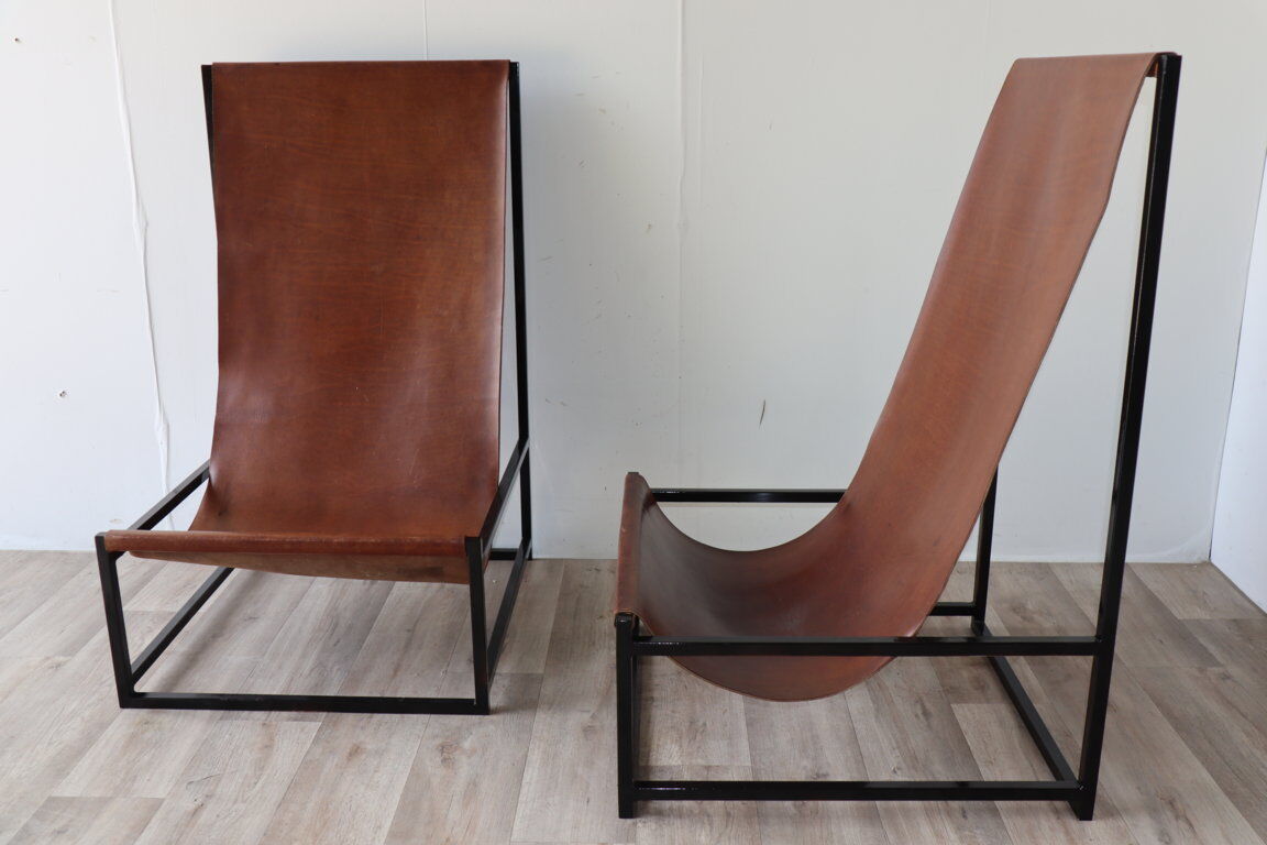Pair of vintage armchairs in stretched leather and metal structure