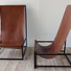 Pair of vintage armchairs in stretched leather and metal structure