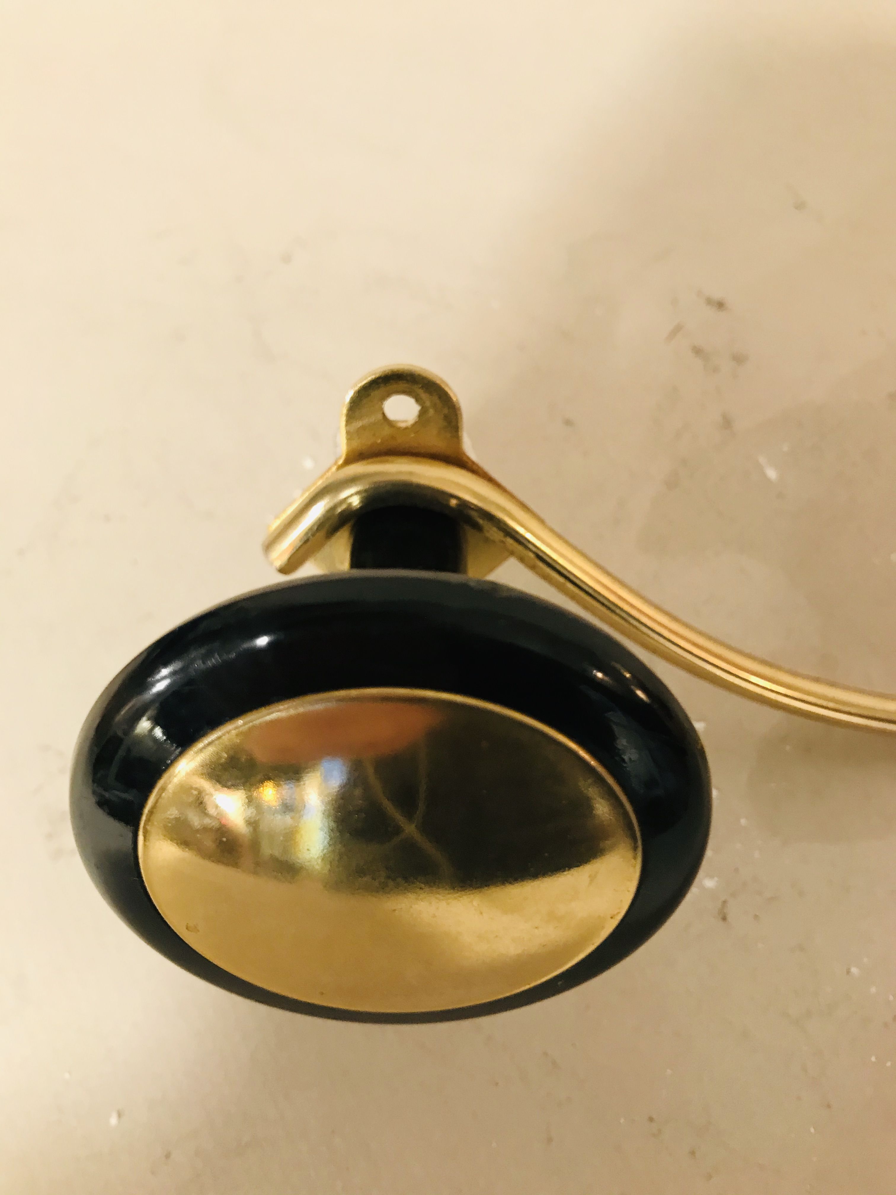 Gold and black metal coatrack 1960