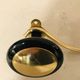 Gold and black metal coatrack 1960