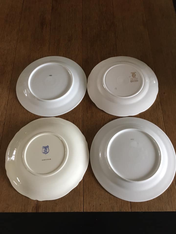 4 mismatched flat plates with floral patterns. Porcelain. Stamped