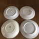 4 mismatched flat plates with floral patterns. Porcelain. Stamped