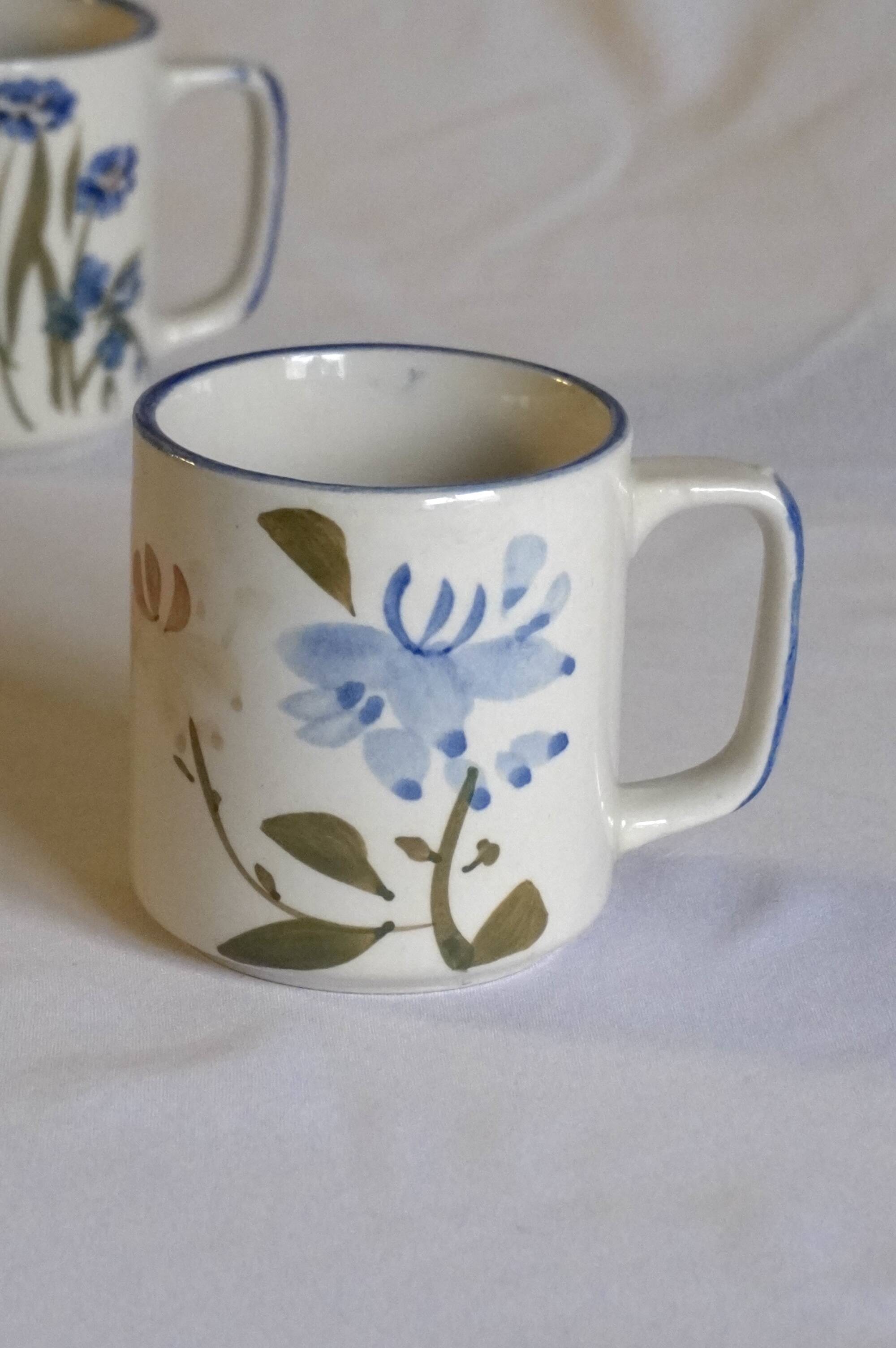 Set of 4 stoneware cups/mugs with blue floral designs, made in China.