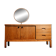 Vintage oak cabinet with circular mirror, 1960s modernist design.
