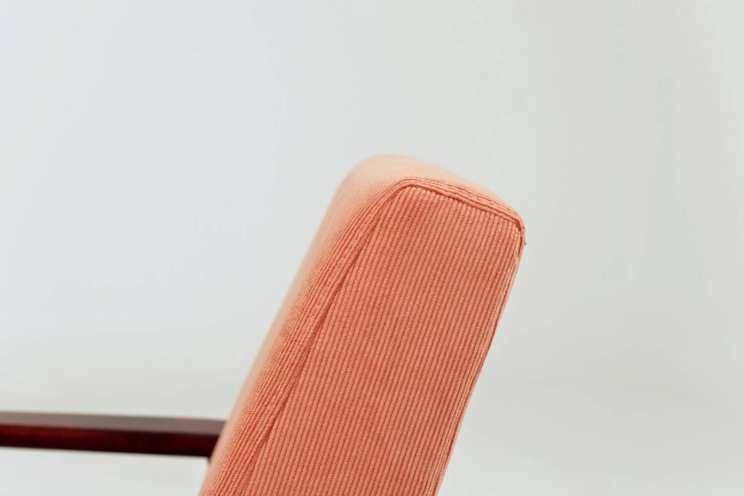 Mid-century modern armchair in coral red designed by H. Lis.