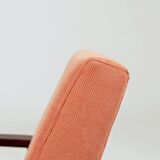 Mid-century modern armchair in coral red designed by H. Lis.