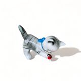 Little ceramic cat playing with a playful ladybug plays gray and white decoration