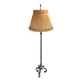 Art Deco floor lamp in bronze metal with a straw yellow fabric shade, twisted shaft, and tripod base.