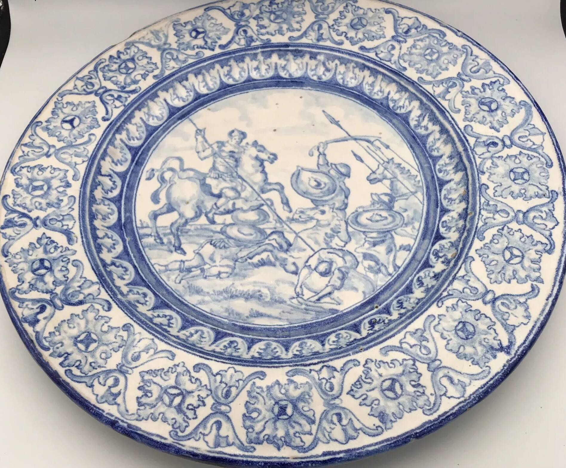 Antique glazed ceramic wall plate with battle scene decoration 41.5 cm