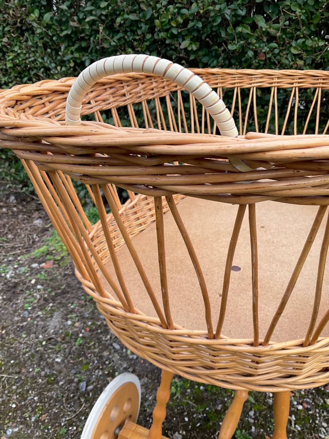 Vintage wicker cradle on casters