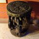 African wooden stool carved in the shapes of characters