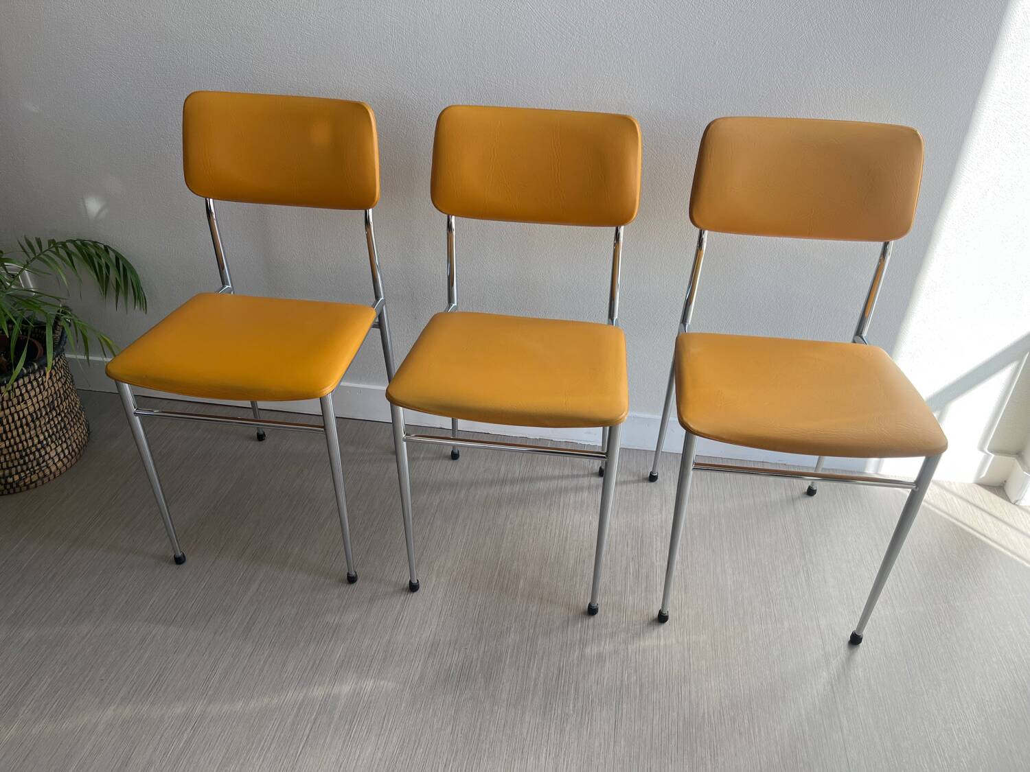 LM vintage chrome and orange/mustard yellow faux leather chairs