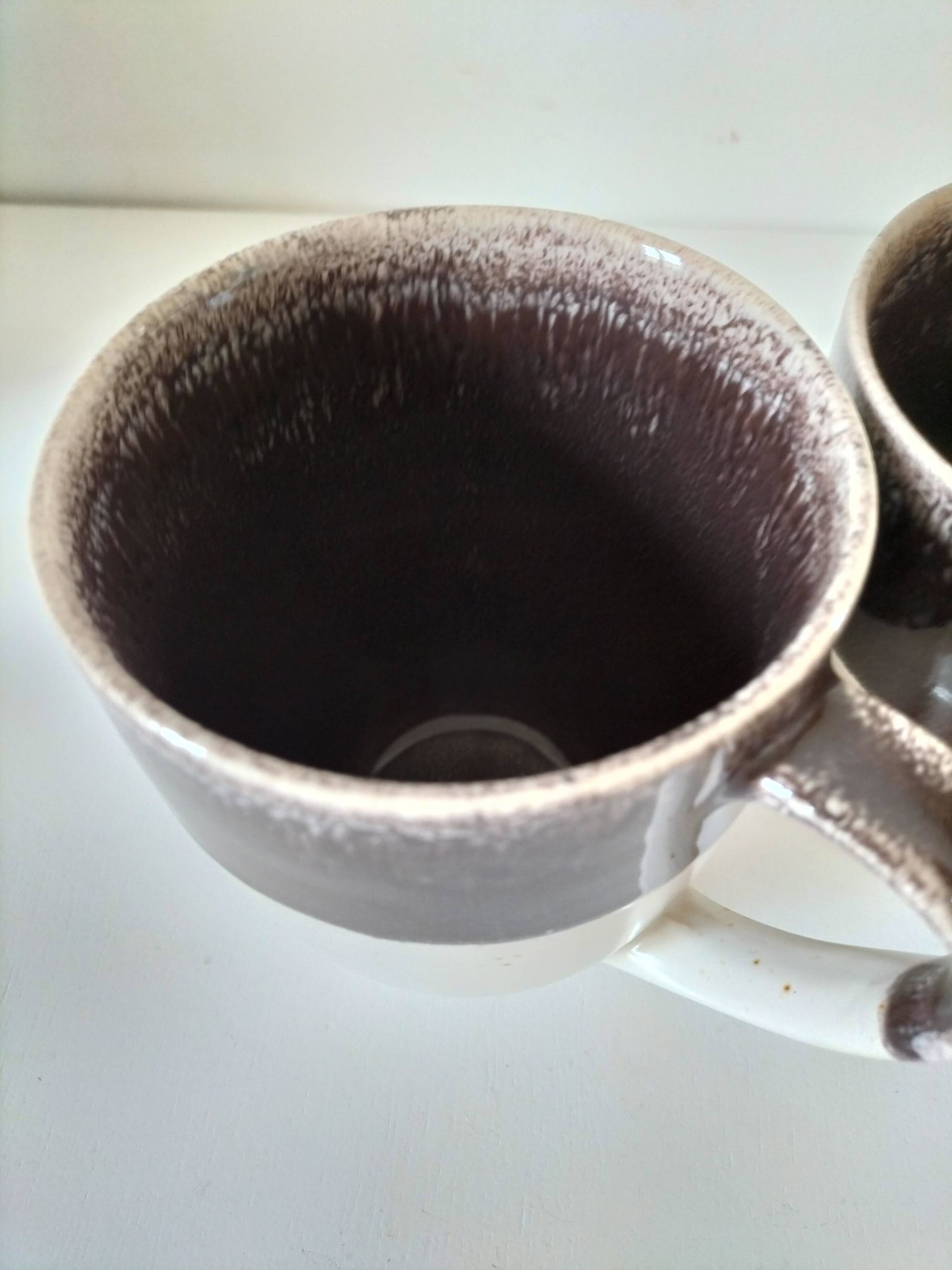 Set of three two-tone mugs, glazed stoneware, café workshop style.