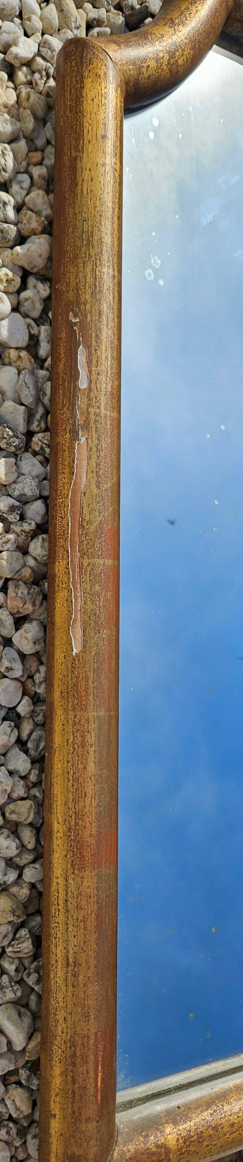 Large gilded wooden mirror in the shape of a gendarme hat