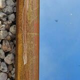 Large gilded wooden mirror in the shape of a gendarme hat