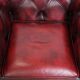 Red English cowhide Chesterfield armchair finished with decorative nails