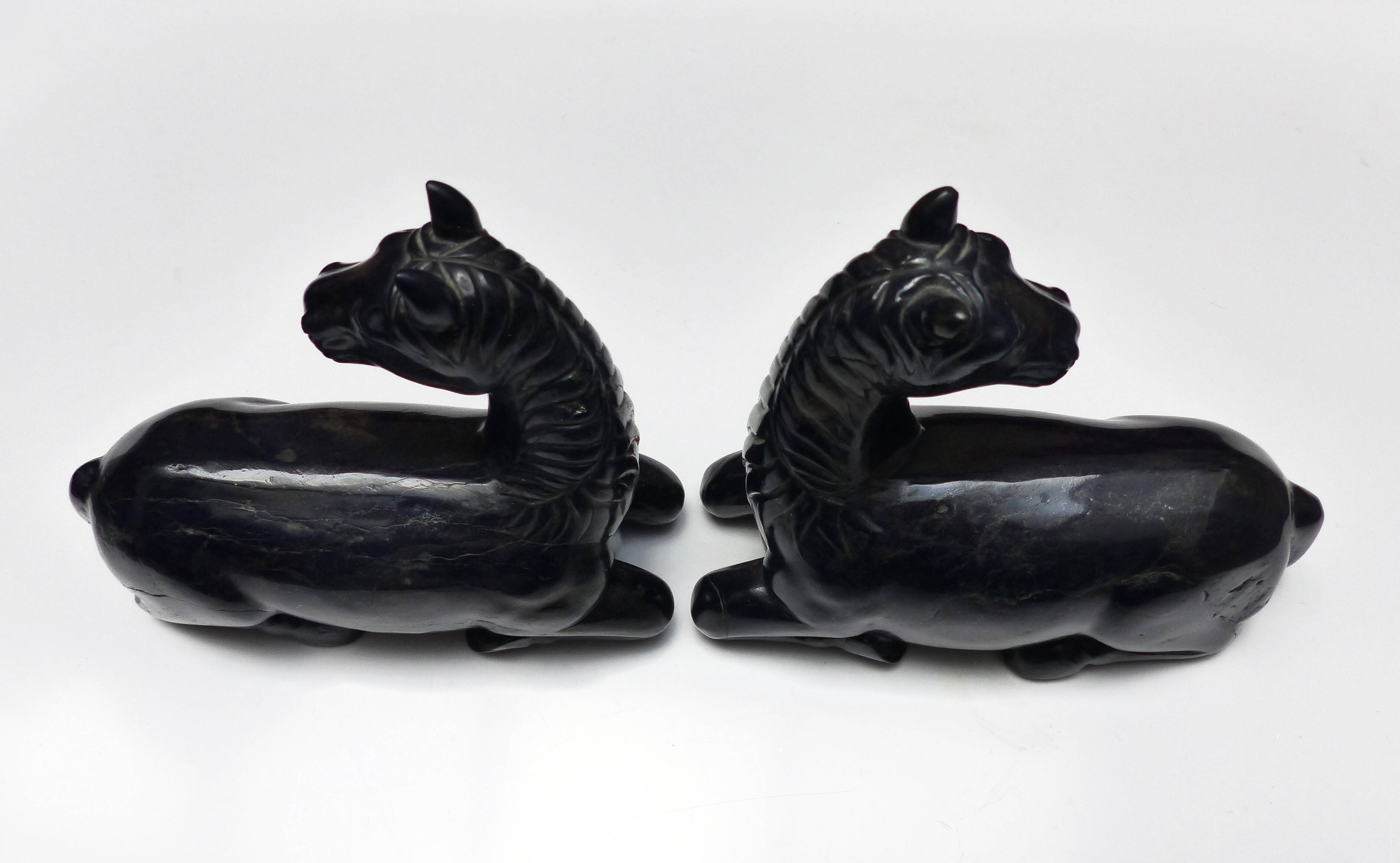 Black marble bookends with lying horses