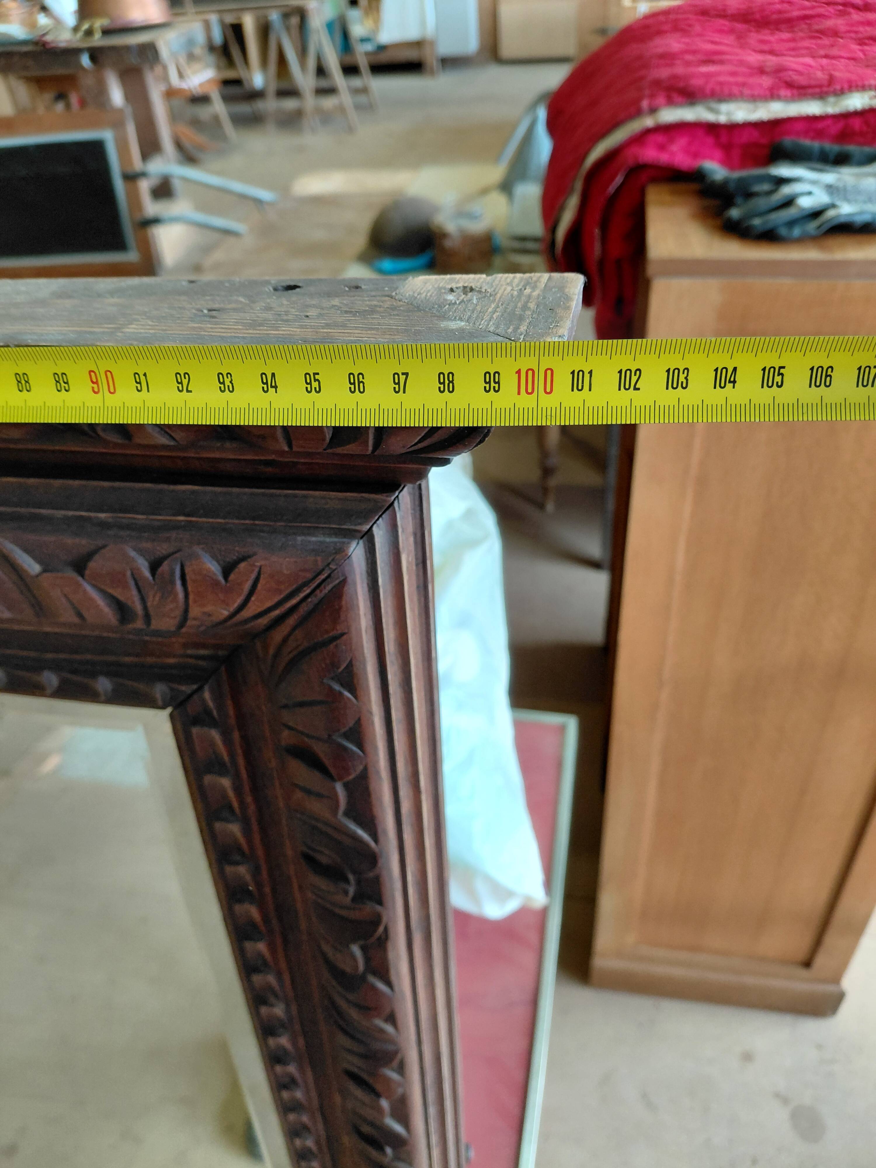 Large bevelled mirror with a carved wooden frame