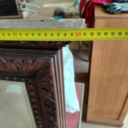 Large bevelled mirror with a carved wooden frame