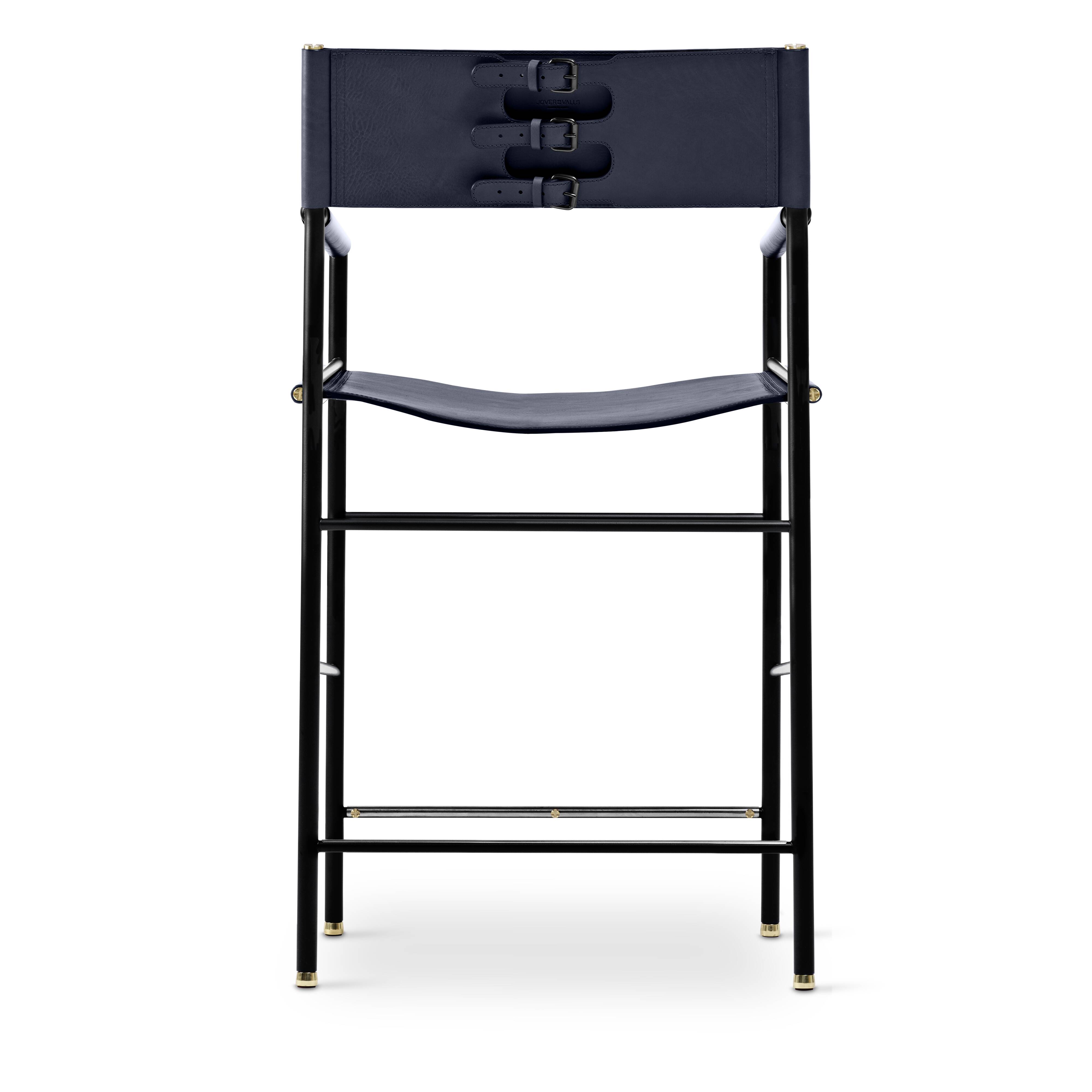 A pair of bar stools with a navy blue leather backrest and black rubber.