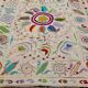 White suzani kilim rug with embroidered multi-colored patterns