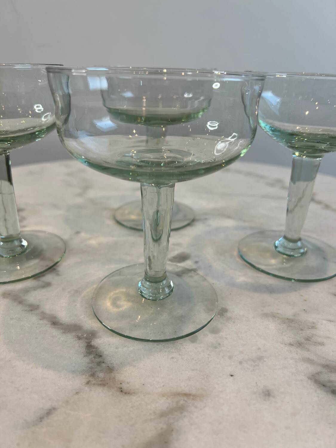 Set of four blown glass stemmed glasses.